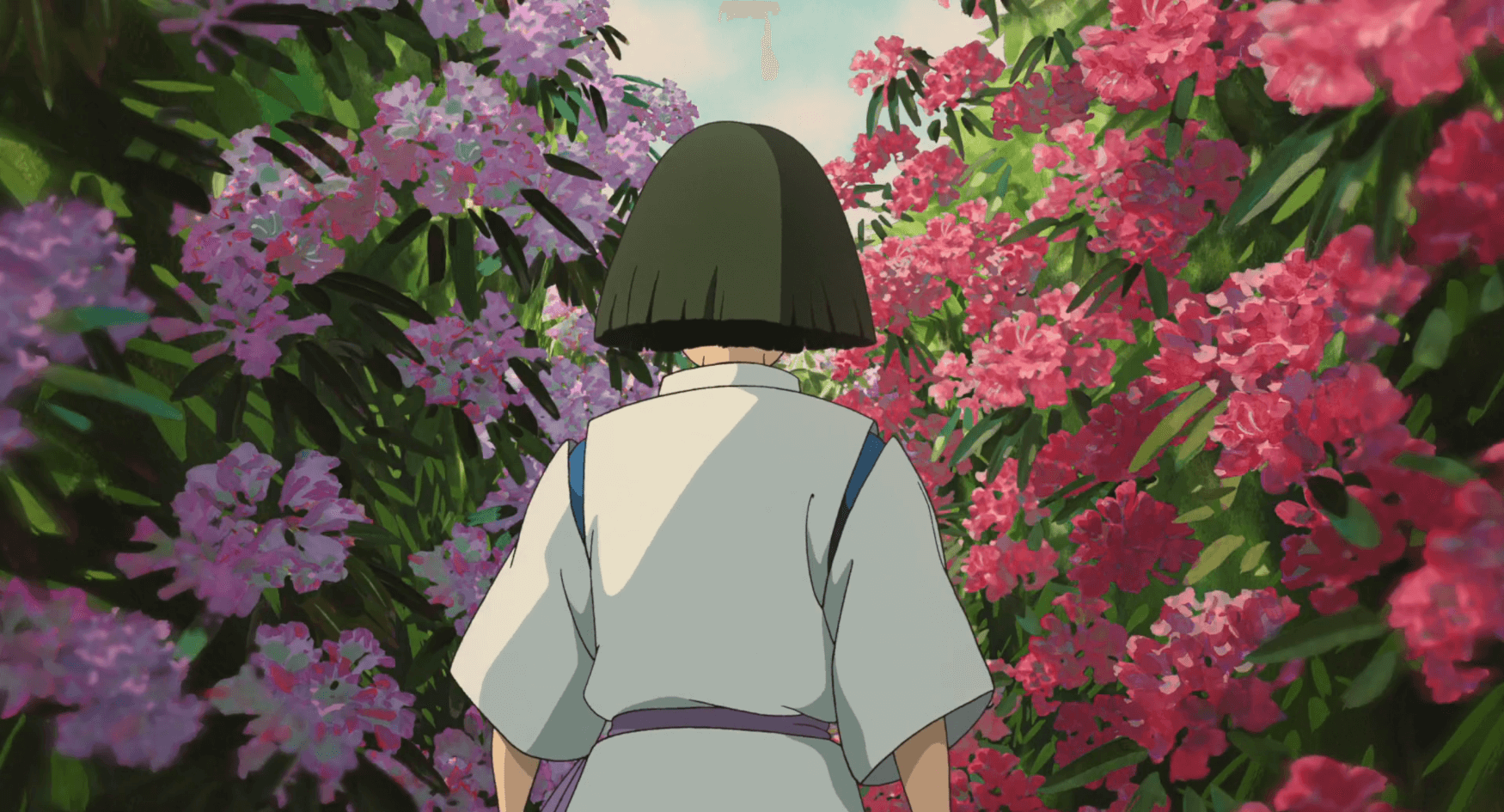 Haku walking through a corridor of flowers